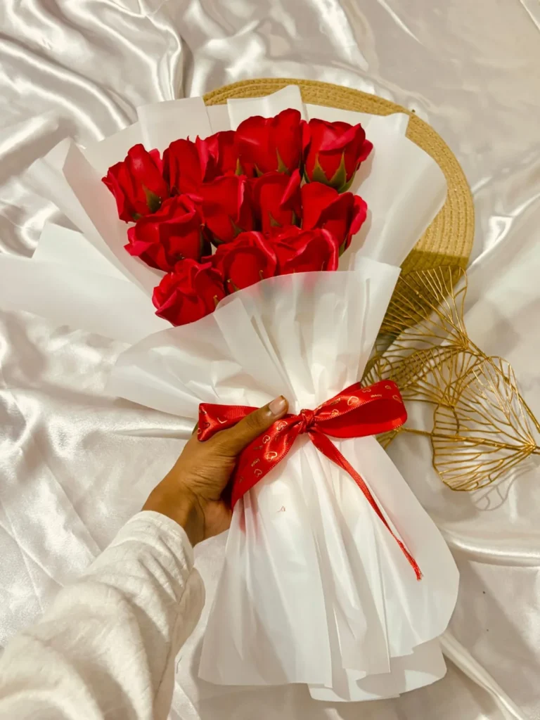 Red rose bouquet arranged as a customized Valentine’s Day gift hamper with elegant white wrapping