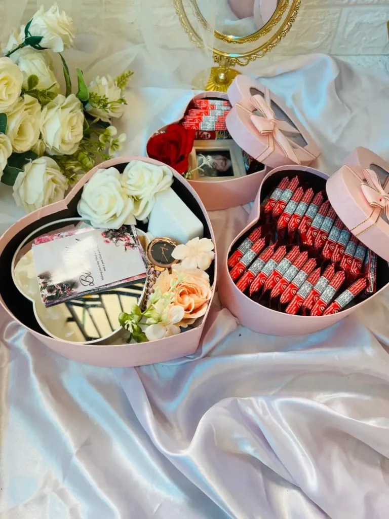 Heart box style customized gift hampers with chocolates and flowers